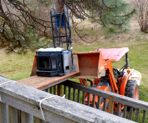 Gary's lifting the new wood-burning fireplace insert up to the second floor.